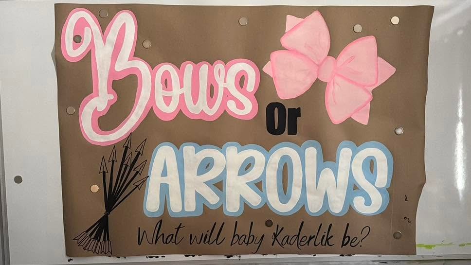 Hand-painted "Bows or Arrows" gender reveal banner by Banner Barn